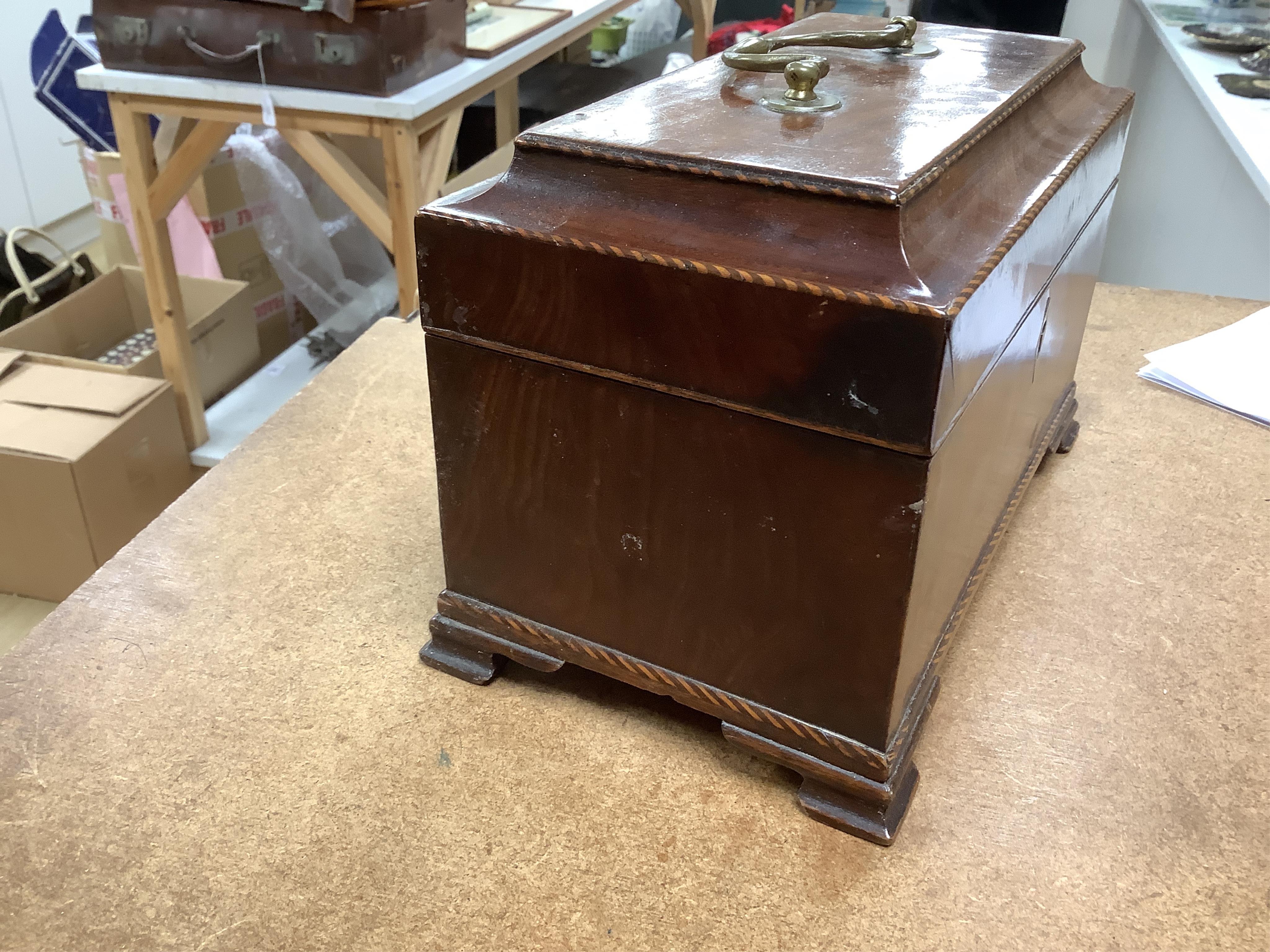 A George III mahogany tea caddy, containing tinned metal canisters, 25cm wide